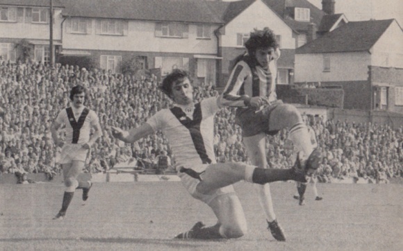 Peter Ward beats a defender to get in a shot.