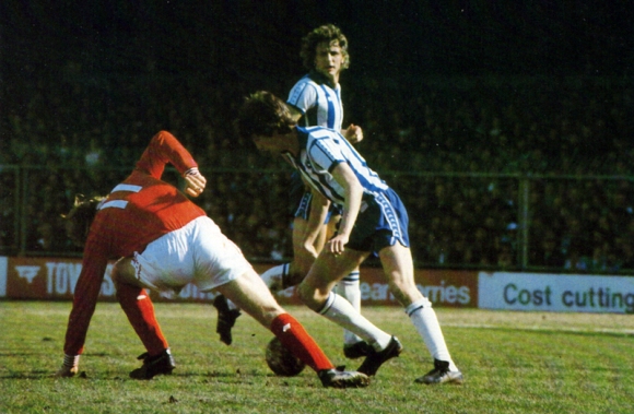 Lawrenson uses his skill to put Gary Churchouse off balance, while Rollings covers the space behind.